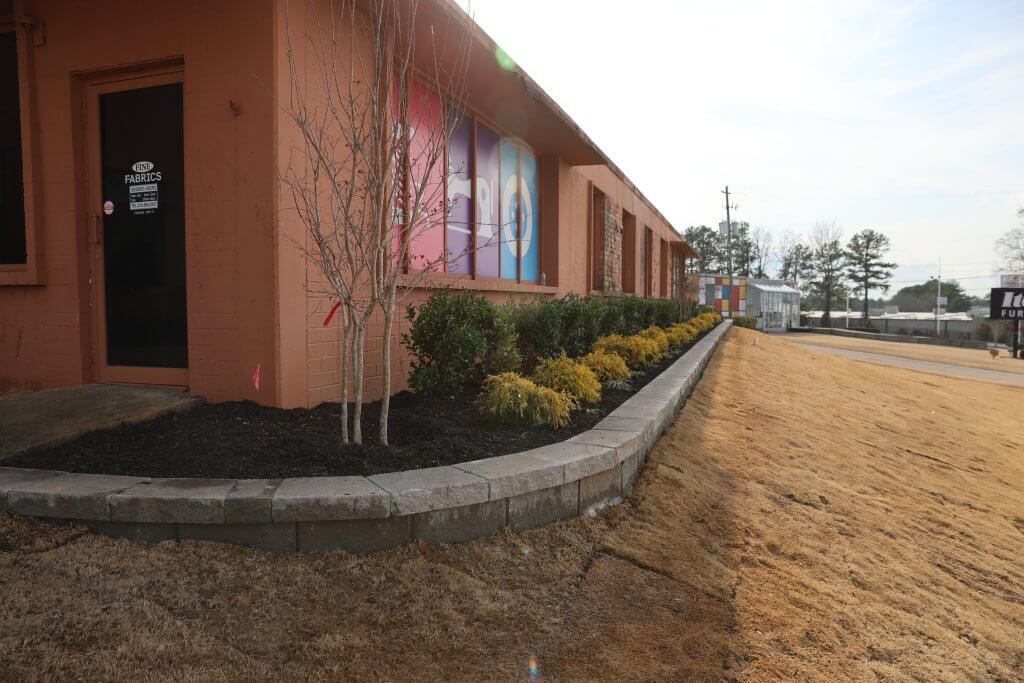 A well-maintained corporate office park exterior featuring manicured lawns and clean walkways that represent a property managed under a comprehensive commercial landscape contract.